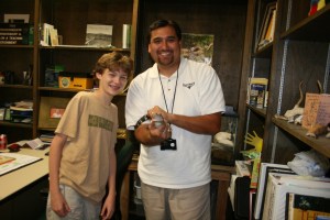 Joe and FWNC&R naturalist Mike Perez with a baby alligator. Alligators NEVER make good pets. This snappy friend is only used for educational and research purposes.